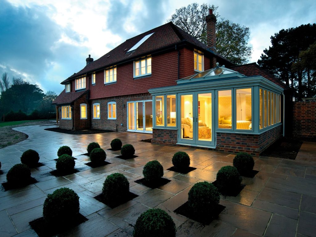 grand house with white timber orangery