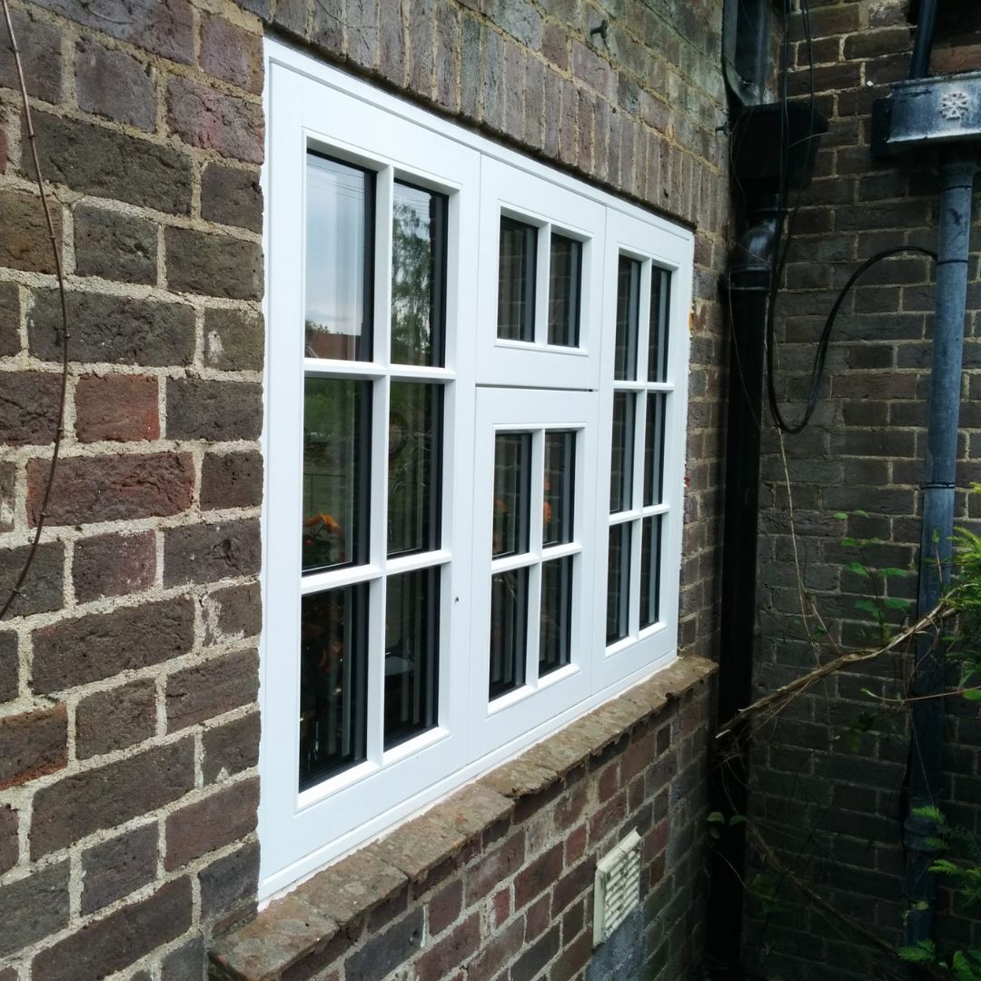 flush casement window on dark brick home
